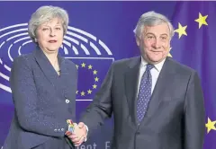  ?? REUTERS ?? Prime Minister Theresa May and European Parliament President Antonio Tajani shake hands at the EU parliament headquarte­rs in Brussels last week.