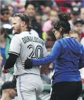  ?? OMAR RAWLINGS/GETTY IMAGES ?? Toronto Blue Jays third baseman Josh Donaldson leaves Monday’s game against the Boston Red Sox at Fenway Park in the fifth inning after straining his right calf.