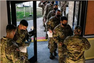  ?? THE NEW YORK TIMES ?? Soldiers line up for medical screening before receiving the coronaviru­s vaccine at Fort Bragg last week. Many younger troops have declined, citing safety. Others seek to exercise personal freedom, which is otherwise mostly lacking in the armed forces.