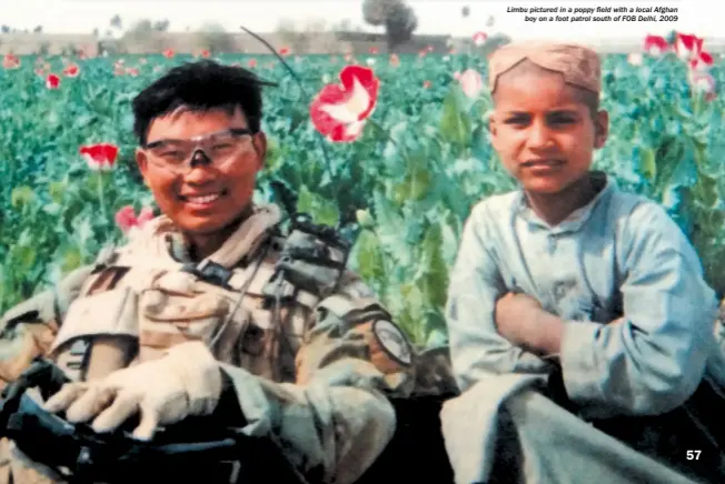  ??  ?? Limbu pictured in a poppy field with a local Afghan boy on a foot patrol south of FOB Delhi, 2009