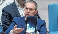  ?? PHOTO: REUTERS ?? Graphic evidence . . . Israel's Ambassador to the United Nations, Gilad Erdan, shows a video of Iranian missile attacks as he speaks to members of the Security Council.