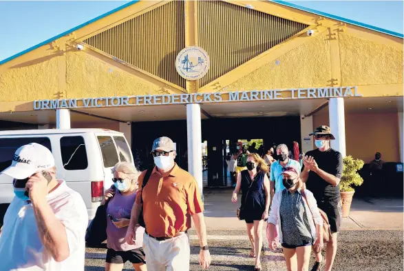  ?? GABBY JONES/THE NEW YORK TIMES ?? People exit from a ferry terminal last month in Saint Thomas in the U.S. Virgin Islands.