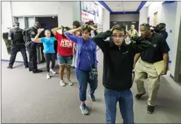  ?? DOUGAL BROWNLIE — THE GAZETTE FILE ?? Students are led out of school as police take part in an shooter response training exercise at Fountain Middle School in Fountain, Colo.