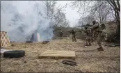  ?? NARIMAN EL-MOFTY — THE ASSOCIATED PRESS ?? Ukrainian soldiers fire their weapons during a training exercise at an undisclose­d location near Lviv, western Ukraine, on Tuesday.