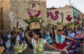  ??  ?? A parade along the Andador de Macedonia Alcala. The Andador connects the Templo de Santo Domingo de Guzmán and the zócalo.