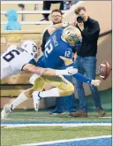  ?? STEPHEN PINGRY/AP ?? Tulsa quarterbac­k Seth Boomer fumbles the ball in the end zone as Connecticu­t's Eddie Hahn defends Saturday.