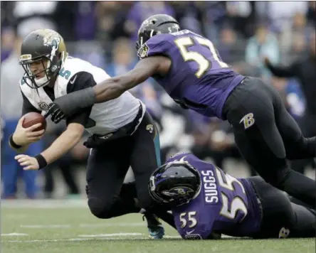  ?? PATRICK SEMANSKY — THE ASSOCIATED PRESS ?? FILE - In this Dec. 14, 2014, file photo, Jacksonvil­le Jaguars quarterbac­k Blake Bortles (5) is sacked by Baltimore Ravens linebacker­s C.J. Mosley (57) and Terrell Suggs (55) during the first half of an NFL football game in Baltimore.