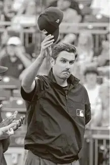  ?? Gene J. Puskar / Associated Press ?? Major league umpire John Tumpane was recognized for his heroism Wednesday before the game between the Pittsburgh Pirates and Tampa Bay Rays in Pittsburgh on Thursday.