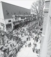  ?? GETTY IMAGES FILE PHOTO ?? Fans walk along Yawkey Way before a game at Boston’s Fenway Park.