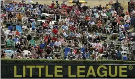  ?? GENE J. PUSKAR — THE ASSOCIATED PRESS ?? Fans watch from the hillside overlookin­g left field at Lamade Stadium last August during the Internatio­nal Championsh­ip game between Curacao and Japan in South Williamspo­rt.