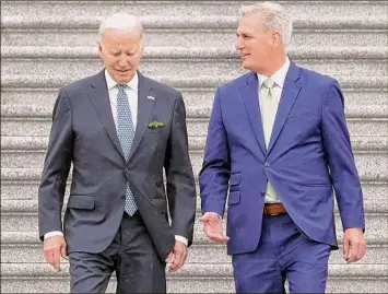  ?? Mariam Zuhaib / Associated Press ?? President Joe Biden and House Speaker Kevin McCarthy of Calif., on Friday walk down the House steps after attending an annual St. Patrick's Day luncheon gathering on Capitol Hill.