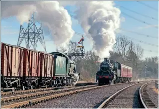  ?? DAVE BOWLES ?? MIXED TRAFFIC: WR ‘Modified Hall’ 4-6-0 No. 6990 Witherslac­k Hall passes ‘2MT’ 2-6-0 No. 46521 at Swithland on January 12.