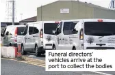  ??  ?? Funeral directors’ vehicles arrive at the port to collect the bodies