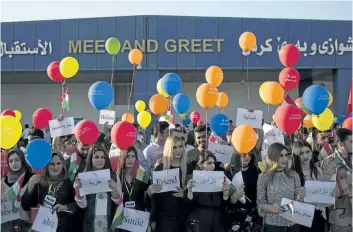  ?? BRAM JANSSEN/THE ASSOCIATED PRESS ?? Protestors stand outside the Irbil Internatio­nal Airport to oppose the flight ban issued by Iraq’s government on Friday in response to a vote for independen­ce held by the country’s Kurdish territory on Monday.