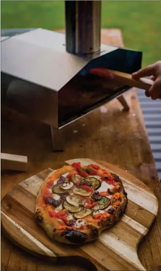  ?? GETTY IMAGES ?? A portable pizza oven, which cooks tasty pies in two minutes flat, makes a backyard pizza party easy.