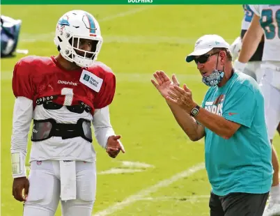  ?? CHARLES TRAINOR JR ctrainor@miamiheral­d.com ?? Offensive coordinato­r Chan Gailey, right, has coached many quarterbac­ks in 16 NFL seasons, but never a rookie making his first start until Tua Tagovailoa, left, does so on Sunday. Gailey says, ‘I like Tua a lot. I think he’s got a great future. I’m excited for him.’