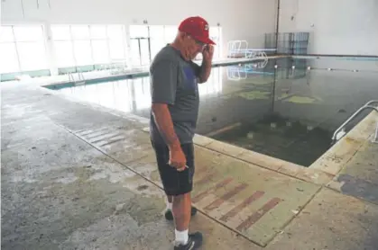  ?? Andy Cross, The Denver Post ?? Principal Dave Casey stands next to the now-shuttered school swimming pool in Deer Trail.