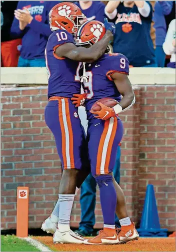  ?? [THE ASSOCIATED PRESS] ?? Clemson’s Joseph Ngata, left, celebrates Travis Etienne’s touchdown during last Saturday’s game against Wofford in Clemson, S.C. The unbeaten Tigers are ranked fifth in the CFP rankings.