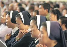  ?? Gary Friedman Los Angeles Times ?? SISTERS FROM the Lovers of the Holy Cross pray at a church in Garden Grove. The Los Angeles-based order has 85 women, many of whom are in their early 30s.