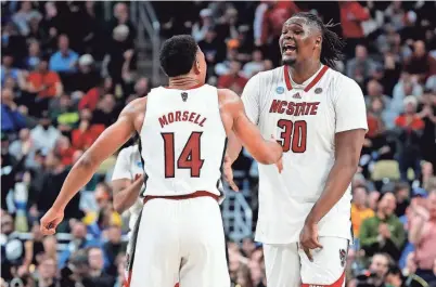  ?? CHARLES LECLAIRE/USA TODAY SPORTS ?? North Carolina State guard Casey Morsell (14) celebrates with forward DJ Burns Jr. (30) after beating Oakland in the second round of the 2024 NCAA Tournament at PPG Paints Arena in Pittsburgh.
