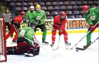  ?? DAVID CROMPTON/Penticton Herald ?? Players from Team Green and Team Red battle for the puck in front of the Team Green net during the annual Penticton Vees Spring Camp Sunday at the South Okanagan Events Centre. Team Green won the game 4-2. Around 150 players from all over Canada and...