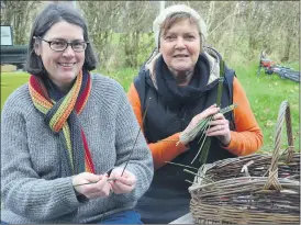  ?? (Pic: John Ahern) ?? Fiona Russell (Doneraile) and Dorothea Gail (Germany) making St. Brigid’s Crosses at last Saturday’s farmers’ market in Killavulle­n.
