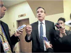  ?? PABLO MARTINEZ MONSIVAIS/THE ASSOCIATED PRESS ?? U.S. Sen. Mark Warne speaks with reporters on Capitol Hill in Washington on Wednesday. He says “people deserve to know” how Twitter and Facebook were used to manipulate Americans during the 2016 election campaign.