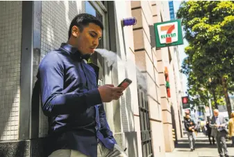  ?? Photos by Gabrielle Lurie / The Chronicle ?? Mark Armendarez smokes near a 7-Eleven in S.F. Nicotine replacemen­t therapy is marketed to smokers as ways to help quit, but such products by themselves won’t do the job, a study said.