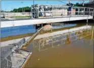  ?? MEDIANEWS GROUP FILE PHOTO ?? Lansdale Wastewater Treatment Plant operator Bob Johnson takes a sludge sample from a tank at the facility in 2013.