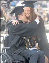  ?? ARIC CRABB — STAFF PHOTOGRAPH­ER ?? Robert Paylor hugs his girlfriend, Karsen Welle, after they received diplomas during Sunday’s commenceme­nt.
