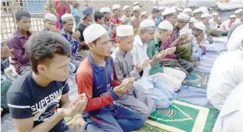  ?? — AFP ?? Rohingya refugees offer Eid al Fitr prayers at a camp mosque in Kutupalong refugee camp in Cox’s Bazar on Saturday.
