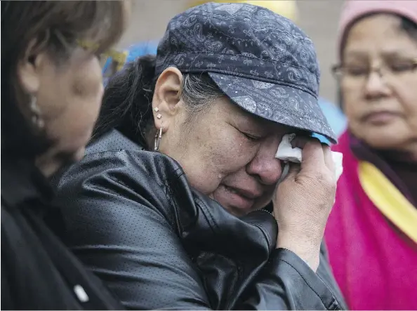  ?? DAVID BLOOM ?? Connie Crier, grandmothe­r of slain toddler Anthony Raine, weeps Tuesday during a vigil outside the Good Shepherd Anglican Church.