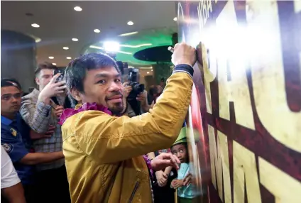  ?? CONTRIBUTE­D FOTO / WENDELL ALINEA ?? FIREWORKS. Manny Pacquiao signs a backdrop at the Le Meridien Hotel of his fight with WBA welterweig­ht champion Lucas Matthysse this weekend in Kuala Lumpur, Malaysia.