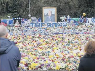  ??  ?? Relocated tributes left for the victims of the helicopter crash, at a new memorial site near the King Power Stadium.