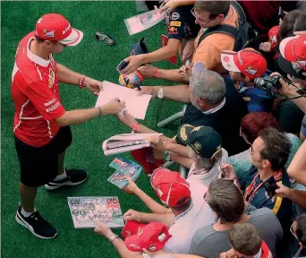  ??  ?? Il ferrarista Sebastian Vettel, 30 anni, 4 volte iridato, mentre firma autografi al GP d’Austria 2017 GETTY