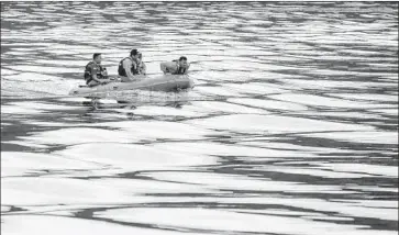  ?? Dedi Sinuaji EPA/Shuttersto­ck ?? SEARCHERS scour Indonesia’s Lake Toba for ferry victims. More than 190 people remained unaccounte­d for.