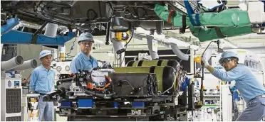  ??  ?? Upbeat mode: Global demand for electronic­s and cars are cited among factors behind bullish manufactur­ing sentiment seen in the Reuters poll. — Bloomberg