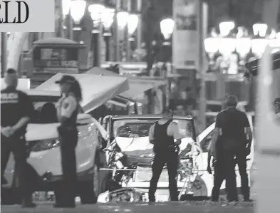  ?? MANU FERNANDEZ / THE ASSOCIATED PRESS ?? Police officers stand near the van involved in a terror attack on Las Ramblas in Barcelona on Thursday.