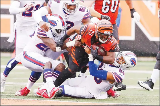  ??  ?? Cincinnati Bengals running back Giovani Bernard (25) is tackled by Buffalo Bills strong safety Micah Hyde (23) in the first half of an NFL football game, on Oct 8, in Cincinnati. (AP)