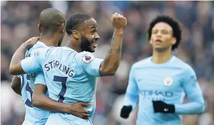  ??  ?? Manchester City’s Raheem Sterling (centre) celebrates after teammate Fernandinh­o (left), scored his side’s fourth goal during the English Premier League match against West Ham United at the London Stadium yesterday. City won the match 4-1.