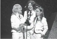  ?? ?? Phoebe Bridgers, from left, Lucy Dacus and Julien Baker of Boygenius accept the award for Best Rock Performanc­e.