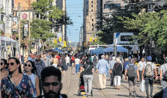  ?? REUTERS ?? People walk along King Street West at the Toronto Internatio­nal Film Festival (TIFF) in Toronto, Sept. 8, 2022.