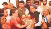  ??  ?? Congress president Sonia Gandhi gives a bouquet to PM Manmohan Singh at a farewell dinner at her residence in New Delhi.