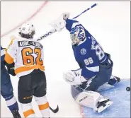  ?? FRANK GUNN — FOR THE CANADIAN PRESS ?? Flyers right wing Nicolas Aube-Kubel (62) scores on Tampa Bay Lightning goaltender Andrei Vasilevski­y, right, during the first period Saturday at Scotiabank Arena in Toronto.