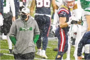  ?? CHARLES KRUPA AP ?? Jets coach Adam Gase (left) leaves the field on Sunday. After a 9-23 record in two years, he was later fired.