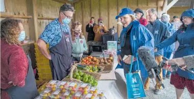  ?? Photos / Peter Meecham, Peter De Graaf ?? Clockwise from far left: Judith Collins passes by at the knife sharpeners’ stall, Clevedon market; at Kerikeri clothing store caravan; checking the produce at Clevedon; visiting a kiwifruit orchard in Kerikeri.