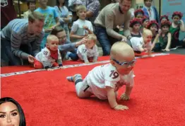  ?? — AFP ?? Babies take part in a race to mark the internatio­nal Children Day in Vilnius, Lithuania, on Thursday. Ten-month-old Mykolas Pociunas (above) crawled to victory and was crowned Lithuania’s fastest toddler. He was lured across the finish line by a box of...