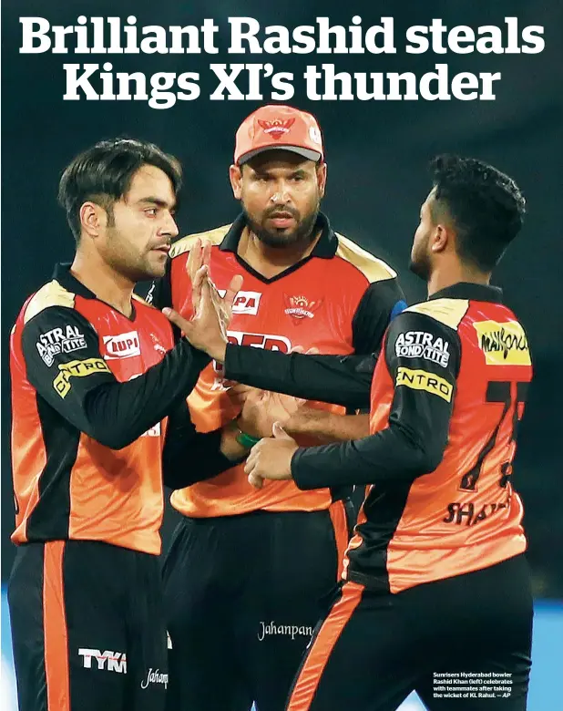  ?? AP ?? Sunrisers Hyderabad bowler Rashid Khan (left) celebrates with teammates after taking the wicket of KL Rahul. —