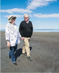  ??  ?? Jamie Lamb strolls on the flats at Boundary Bay with his wife, Betsy.