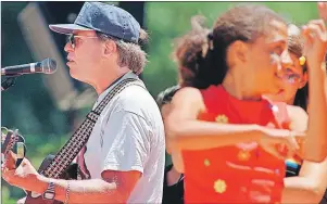  ?? AP PHOTO ?? In this June 21, 1997, file photo, Country Joe McDonald, left, an anti-Vietnam War protester and 1960s rock icon, sings “Carry On,” a healing song of peace, during San Francisco’s 30th anniversar­y celebratio­n of the “Summer of Love.”